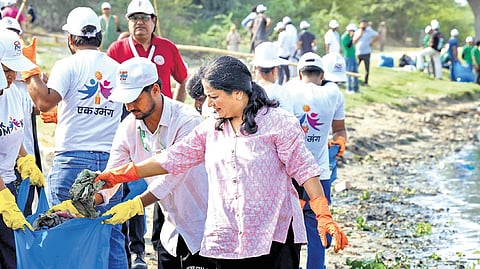 Chief Minister Rekha Gupta during a cleanliness drive at Chilla village
