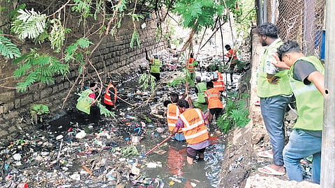 HYDRAA workers remove garbage from drains to prevent monsoon flooding in the city.