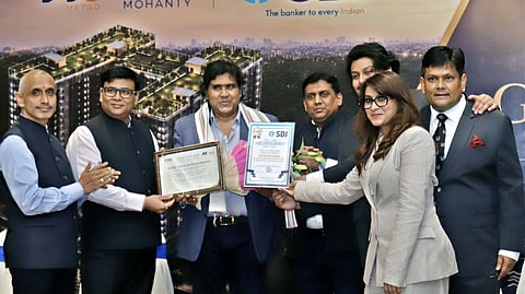 SBI officials handing over the project approval certificate to founder and chairman of Metro Group Peeyush Mohanty on Saturday