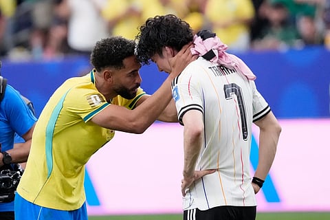 Brazil's Matheus Cunha consoles Japan's Ao Tanaka at the end of the World Cup round of 32 soccer match between Brazil and Japan in Houston on Monday
