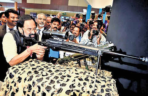 Irrigation Minister N Uttam Kumar Reddy tries his hand at sniper rifle shooting after inaugurating the Aeromart Hyderabad 2026 at Hitex in Hyderabad on Tuesday