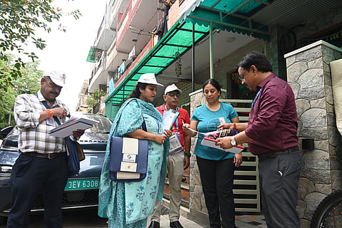 BLOs conduct the Special Intensive Revision (SIR) door-to-door voter verification process at BK Dutt Colony, Jor Bagh, in New Delhi,