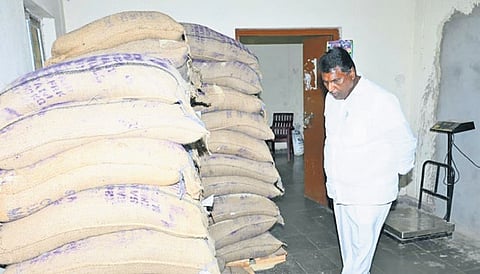 Minister Adluri Laxman Kumar inspects rice bags at the residential school in Mallapur