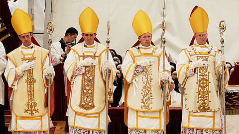 Newly consecrated Bishops, from left, Marc Hanappier, Michel Poinsinet de Sivry, Michael Goldade and Pascal Schreiber wearing their miters and holding their pastoral staffs, stand at the end of their consecration ceremony in a tent set up outside the Society of St. Pius X seminary in Econe, Switzerland, Wednesday, July 1, 2026.