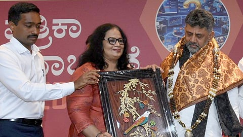 Chief Minister DK Shivakumar being felicitated by Karnataka Media Academy president Ayesha Khanum in the presence of Information Commissioner MN Anucheth during Press Day celebrations in Bengaluru on Wednesday.