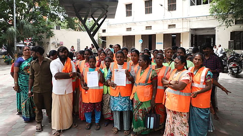 Contract sanitary workers of the Coimbatore City Municipal Corporation arrive at the Corporations main office to submit a petition on Wednesday.