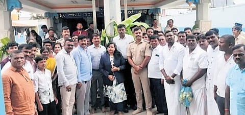 Dalit leaders with Tahsildar CS Poornima and police officials in front of the Anjanaeya Swamy temple at Nidaghatta village in Kadur taluk on Tuesday.
