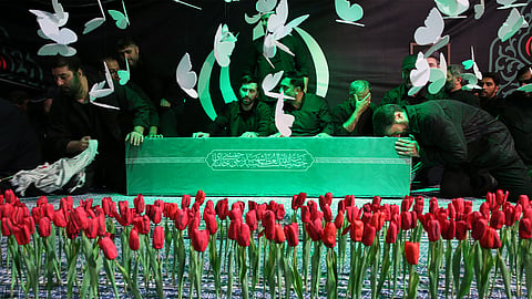 mourners gather around the coffin of Iran's Supreme Leader Ayatollah Ali Khamenei as it lies in a mourning hall adjacent to the Imam Khomeini Hussainiya within the Supreme Leader's compound before his funeral in Tehran, Iran, late Thursday, July 2, 2026.