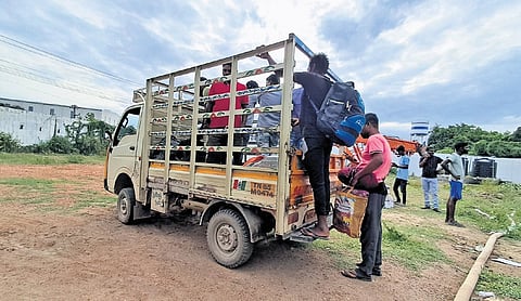 Construction workers staying near the unit being shifted on Friday. A 500-metre radius around the seafood processing plant has been declared as restricted zone.