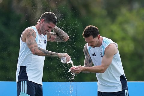 Argentina's Lionel Messi, right, and Rodrigo De Paul spalsh water on themselves to cool down during a training session on the eve of their World Cup round of 32 soccer match against Cape Verde, in Fort Lauderdale, Fla., Thursday, July 2, 2026.
