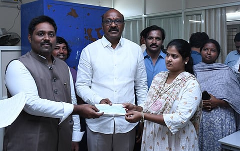Visakhapatnam West MLA Ganababu and VMRDA officials distribute cheques to 16 affected property owners.