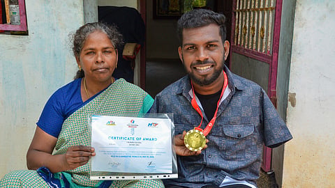 Saju with his mother Theresmary holding the certificate from his win at the Asia Para Taekwondo Championship held in Mongolia in May.