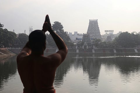 A devotee performing rituals on the occasion of Thai Amavasya at the Kapaleeshwarar Temple in Mylapore, Chennai