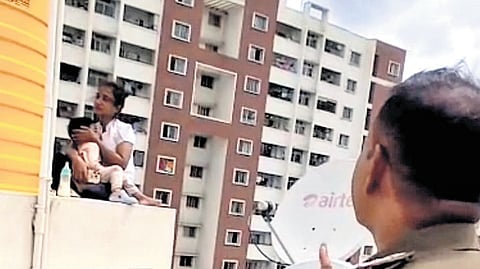 A video grab of the woman with her son atop the terrace
