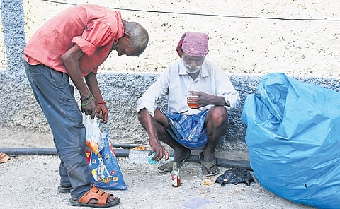 A man seen consuming alcohol by the roadside in Chennai, after temporary closure of Tasmac bar outlets led some customers to drink in public spaces