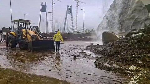 Restoration work underway after debris and boulders partially cover a portion of the Pune to Mumbai carriageway of the Khopoli-Kusgaon 'Missing Link 'near the exit of Tunnel 2 following landslide amid heavy monsoon rains, in Pune district, Maharashtra, Monday, July 6, 2026.