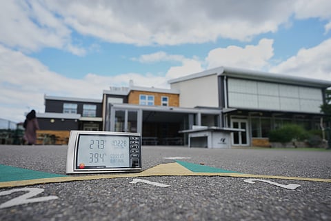 A digital thermometer reads the temperature in the school at Beaconsfield Primary School in London, Wednesday, July 1, 2026.