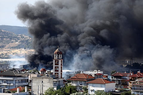 Thick smoke rises above Filothei settlement during a wildfire on the outskirts of the northern city of Thessaloniki, Greece, Sunday, July 5, 2026.