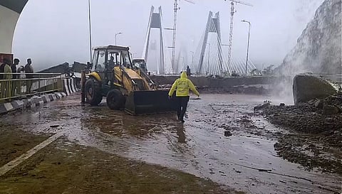 Restoration work underway after debris and boulders partially cover a portion of the Pune to Mumbai carriageway of the Khopoli-Kusgaon Missing Link near the exit of Tunnel 2 following landslide amid heavy monsoon rains, in Pune district, Maharashtra, Monday, July 6, 2026.