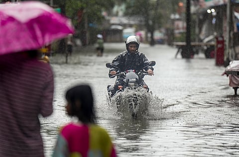 People wade through a waterlogged street in Mumbai, Maharashtra, on Monday, July 6, 2026.