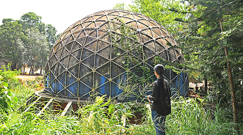 A student in front of the defunct planetarium at the College of Engineering, Trivandrum