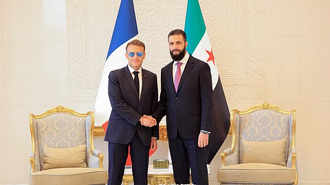 France's President Emmanuel Macron (L) shakes hands with Syrian President Ahmed al-Sharaa ahead of their meeting at the People's Palace in Damascus on July 7, 2026.