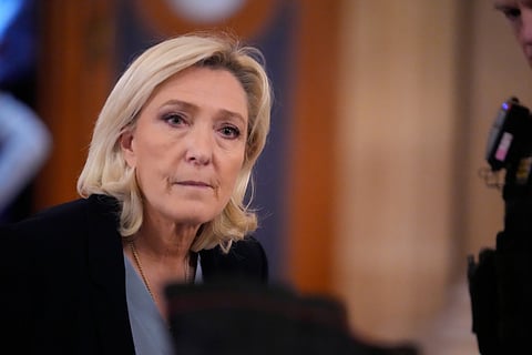 Far-right leader Marine Le Pen walks outside the courtroom during a short break in her appeals trial in Paris, on Jan. 20, 2026.