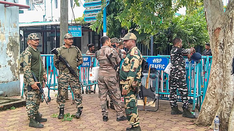Security personnel stand guard outside Baruipur Sub-Divisional Hospital, where the body of an accused killed in a police encounter has been kept, in South 24 Parganas district, West Bengal, Wednesday, July 8, 2026.