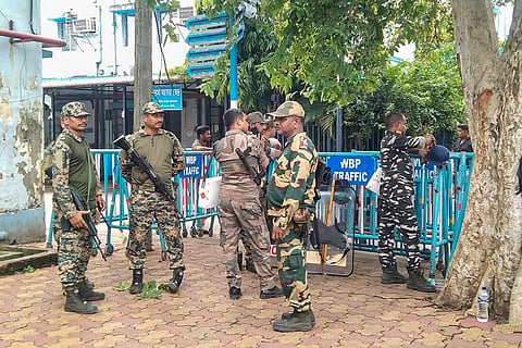 Security personnel stand guard outside Baruipur Sub-Divisional Hospital, where the body of an accused killed in a police encounter has been kept, in South 24 Parganas district, West Bengal, Wednesday, July 8, 2026.