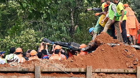 Bodies of landslip victims being taken to ambulances from the site at Kalladi in Wayanad on Tuesday
