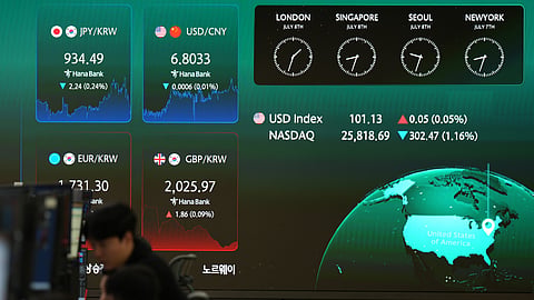 Dealers talk near the screens showing foreign exchange rates at a dealing room of Hana Bank in Seoul, South Korea, Wednesday, July 8, 2026.