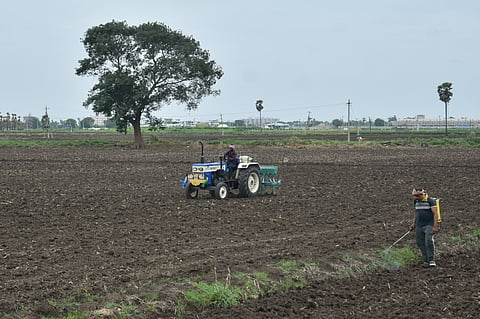 Expecting a good rainfall in the coming days, a farmer ploughs his agricultural field with a tractor to sow a fresh crop at Tadepalli in Guntur district.