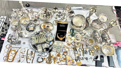 Cash and ornaments seized from the residence of a government official during the raid on Wednesday.