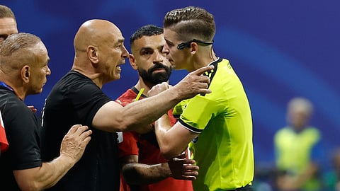 Egypt head coach Hossam Hassan argues with referee Francois Letexier, of France, during the World Cup round of 16 soccer match between Argentina and Egypt in Atlanta, Tuesday, July 7, 2026.