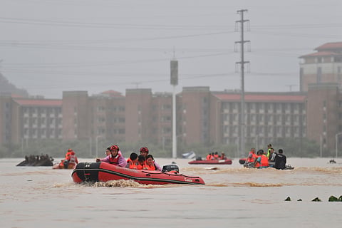 In this photo released by Xinhua News Agency, rescuers evacuate stranded teachers and students at Xijiang education park in the aftermath of tropical storm Maysak in Guigang City, south China's Guangxi Zhuang Autonomous Region, July 8, 2026.