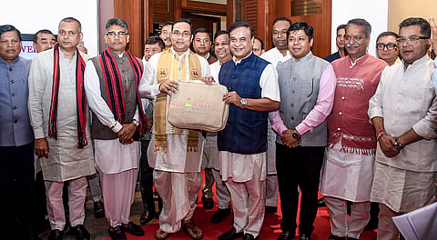 Assam Chief Minister Himanta Biswa Sarma along with state Finance Minister Jayanta Malla Baruah and others pose for photographs as they arrive to present the budget for the financial year 2026-27 during the budget session of 16th Assam Legislative Assemblyin Guwahati.