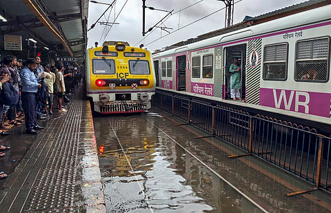 A train runs on a waterlogged railway track amid rain, at Nalasopara in Palghar, Maharashtra, Tuesday, July 7, 2026.