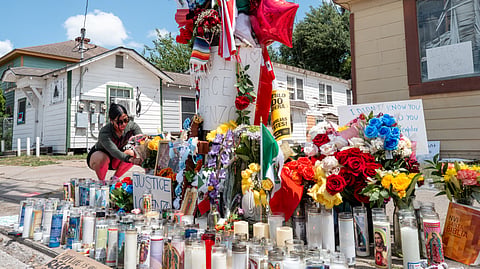 A person places flowers at the site where Mexican immigrant Lorenzo Salgado Araujo was killed on July 09, 2026 in Houston, Texas.