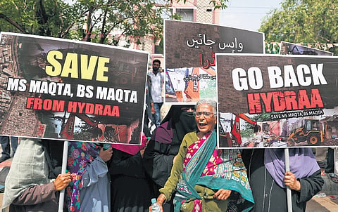 Residents stage a protest, demanding that HYDRAA cancel plans for any demolitions in MS Maqta and BS Maqta, in Hyderabad on Friday.