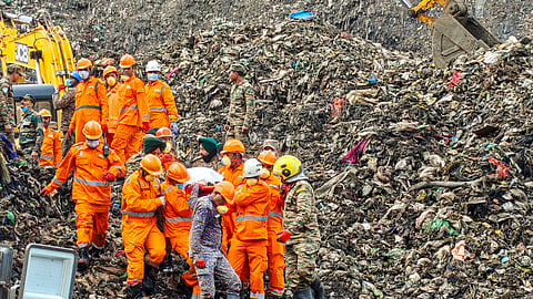Rescue personnel carry a body during rescue operations at the site where a three-storey administrative building collapsed at the Pimpri Chinchwad Municipal Corporation's waste-to-energy plant in Moshi following heavy rainfall, in Pune, Thursday, July 9, 2026.