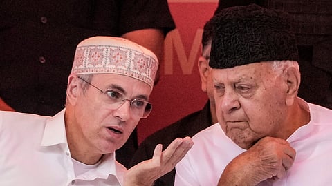 Jammu & Kashmir Chief Minister Omar Abdullah, left, interacts with Jammu & Kashmir National Conference (JKNC) President Farooq Abdullah during the workers convention, outskirts of Srinagar, Saturday, July 11, 2026.