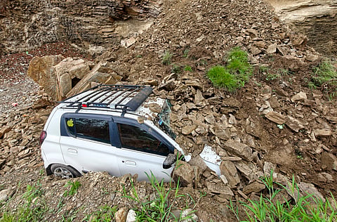 A vehicle buried under debris following a landslide at Rajhana, near New Shimla, Himachal Pradesh, Saturday, July 11, 2026.