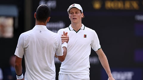 Italy's Jannik Sinner shakes hands with Serbia's Novak Djokovic after winning their men's singles semi-final tennis match at the 2026 Wimbledon Championships on July 10, 2026.