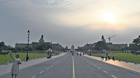 Residents take a stroll on the Kartavya Path on a clear day on Friday.
