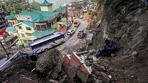 Traffic moves past a landslide site following overnight rainfall, in Shimla, Himachal Pradesh, Sunday, July 12, 2026.