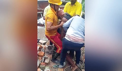 Fire services personnel rescuing the two labourers on Saturday.