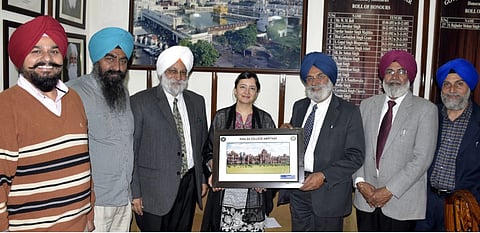 Guneeta Singh Bhalla (centre) receives a plaque at Khalsa College in Amritsar in 2017