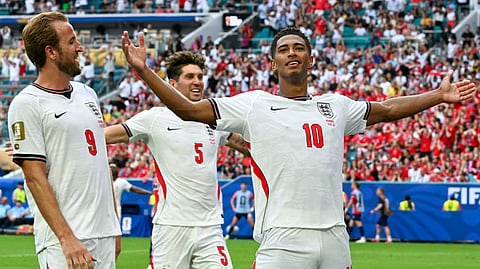England's midfielder #10 Jude Bellingham celebrates scoring his team's second goal with England's forward #09 Harry Kane and England's defender #05 John Stones during the 2026 World Cup quarter-final match between Norway and England at Miami Stadium in Miami on July 11, 2026.