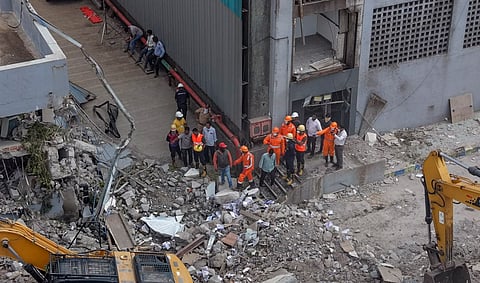 NDRF personnel at the site after a three-storey administrative building of a Waste-to-Energy (WTE) plant run by the Pimpri Chinchwad Municipal Corporation collapsed when an adjacent mound of garbage fell onto the structure like a landslide, in Pune district, Maharashtra, Saturday, July 11, 2026