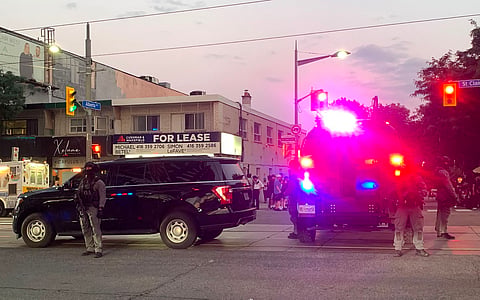 Emergency Task Force vehicles and police officers are seen on the site of a shooting in Toronto, Canada on July 11, 2026.